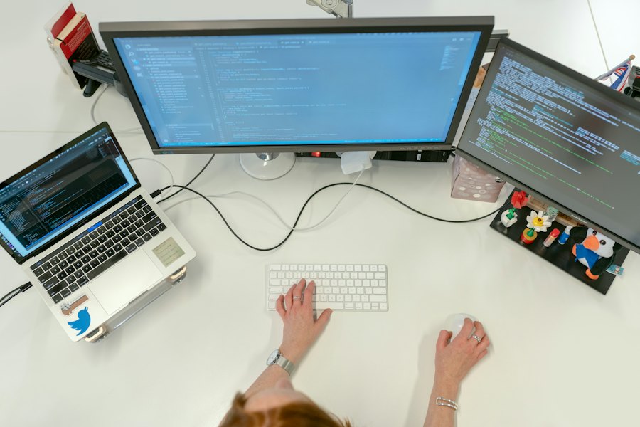 A desk with two monitors and a laptop (stock photo)